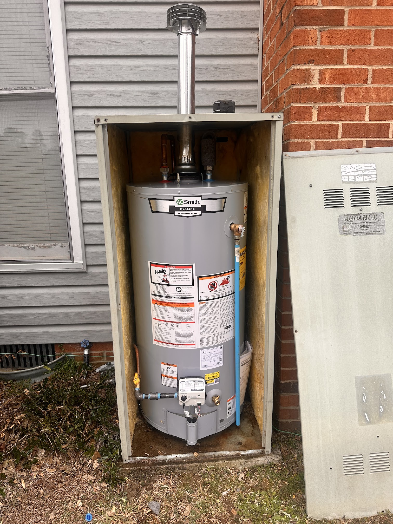 Natural gas water heater replacement installed in an exterior water heater hut