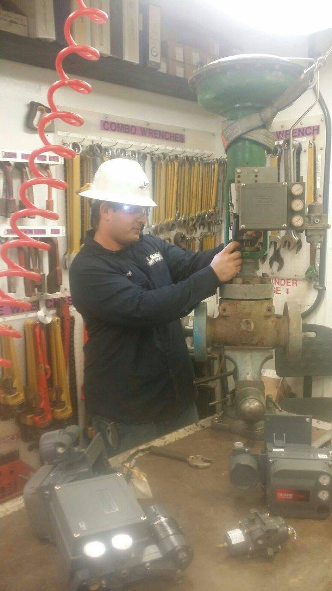 Dave Bayles working on a Fisher control valve positioner in an offshore instrumentation shop