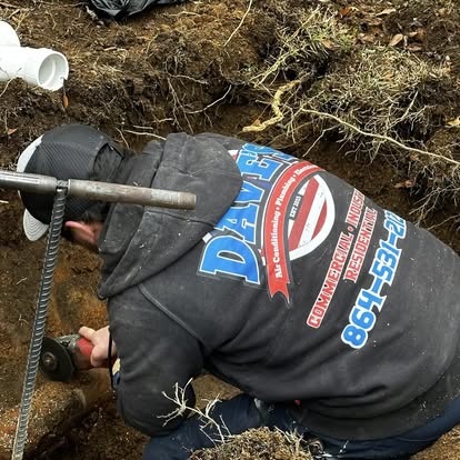 Dave's plumber working in an excavation area during plumbing service