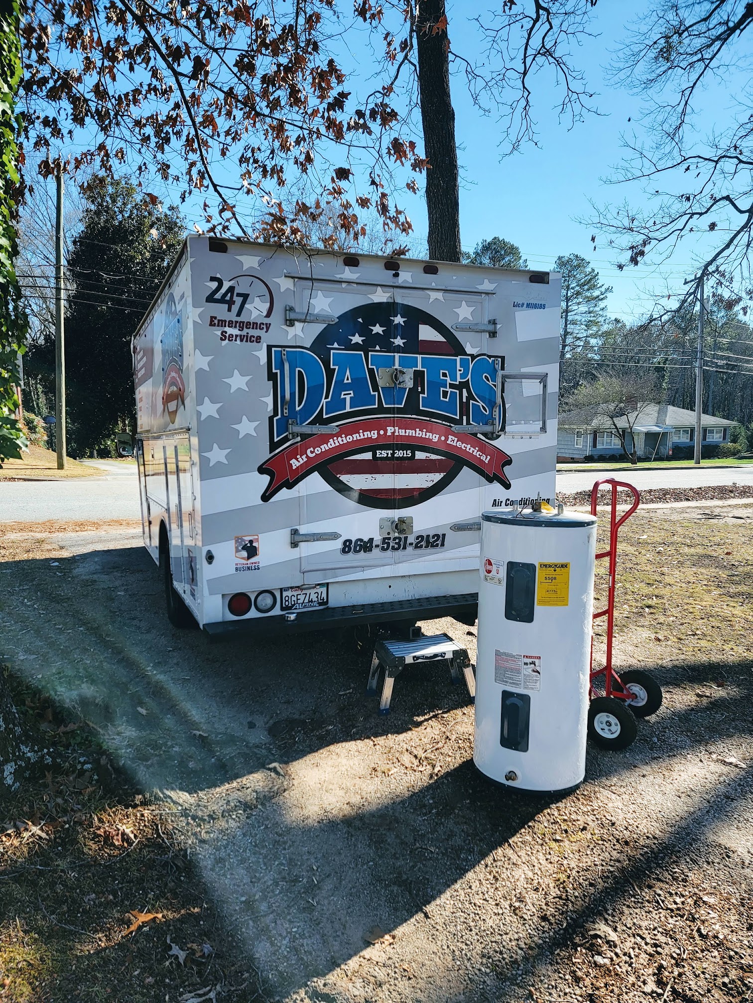 Dave's service van hauling away an old water heater after replacement