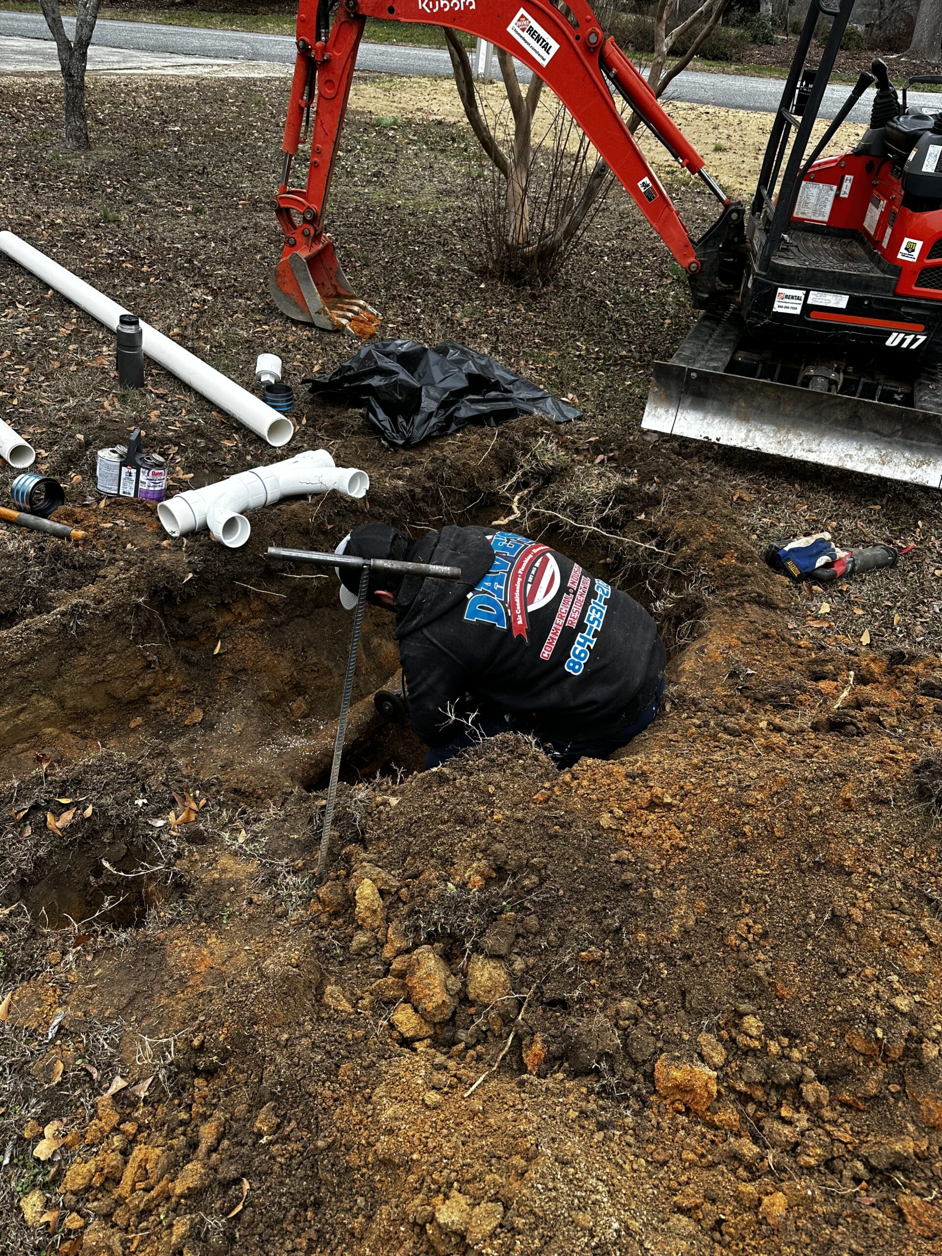 Dave's plumber working in a trench for sewer line repair in the Upstate