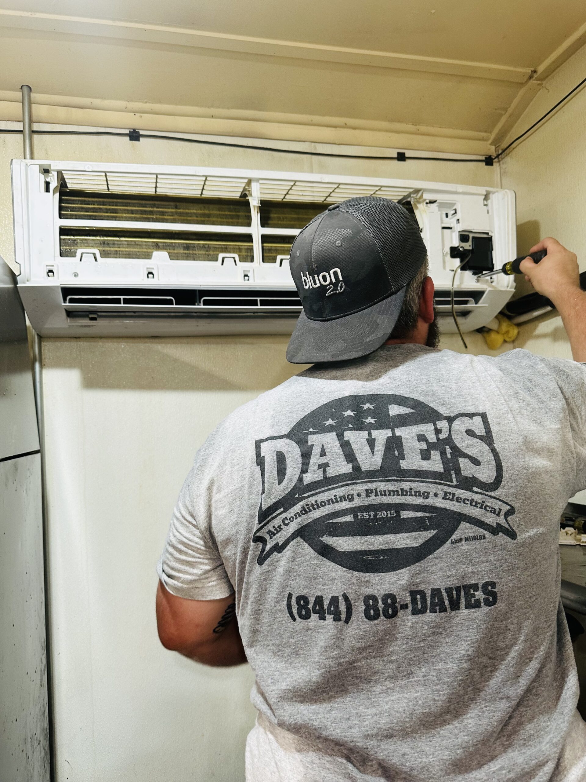 Dave's technician installing a ductless mini-split system for cooling service in Upstate South Carolina
