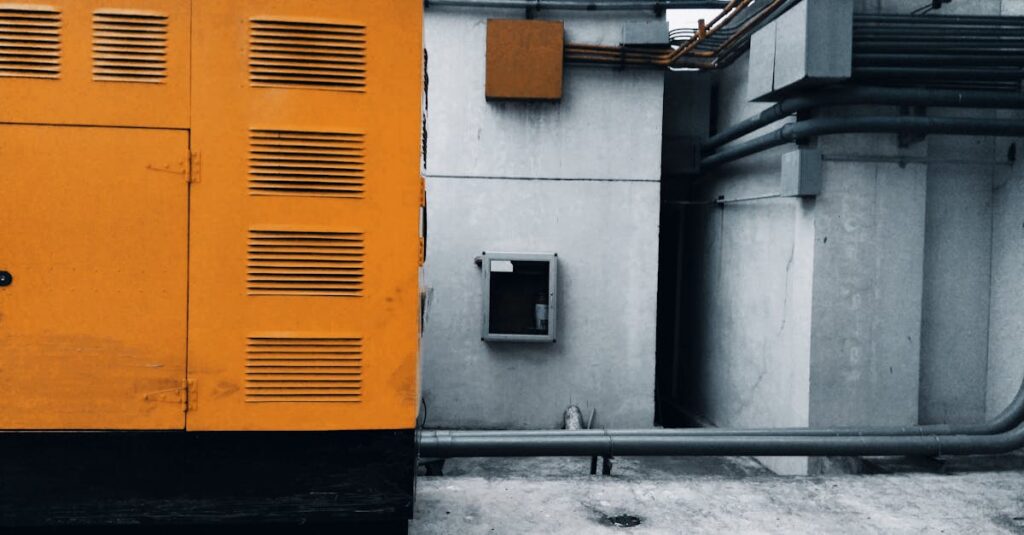 Industrial building exterior with pipes and yellow panel