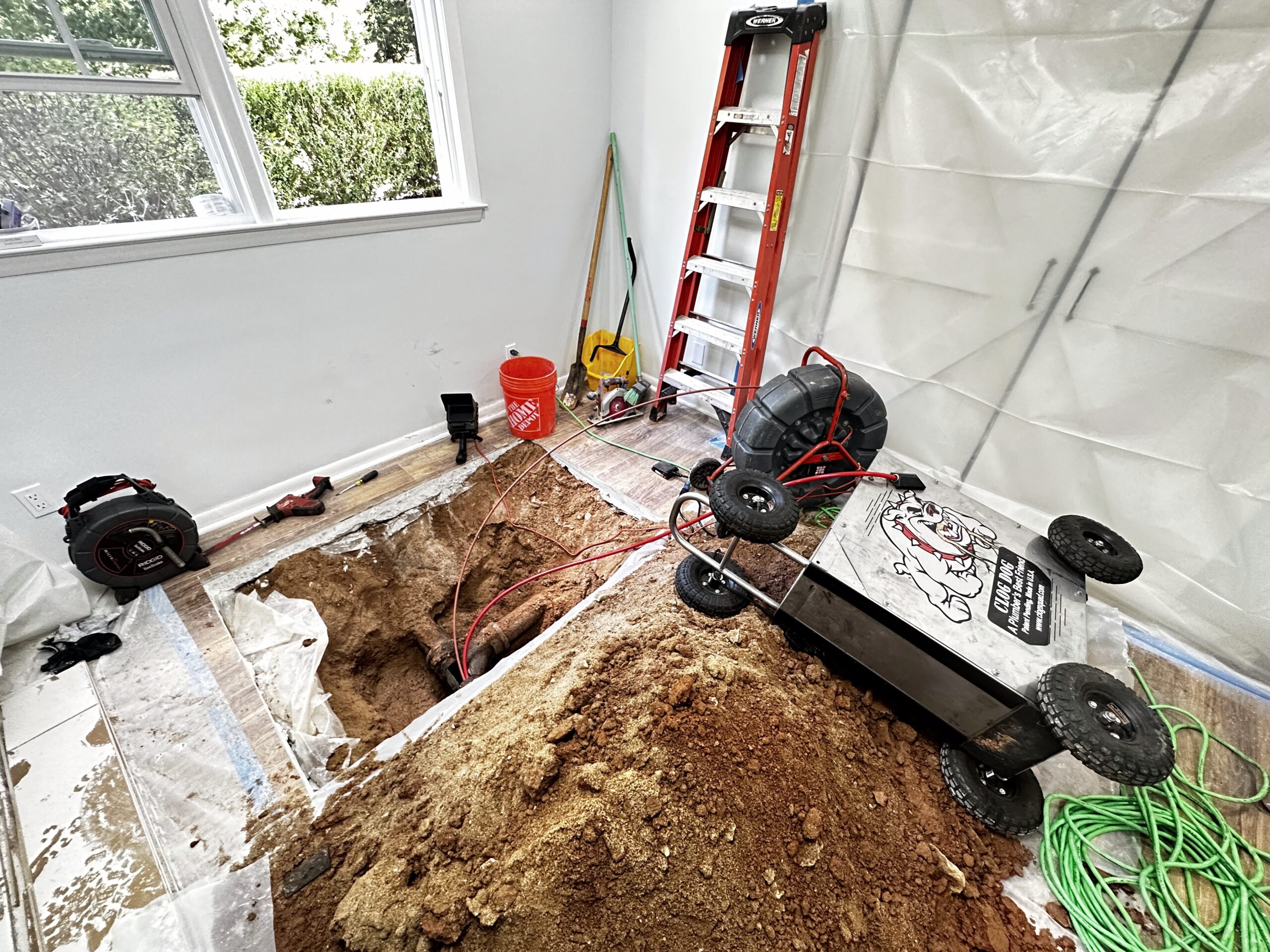 Dave's plumbing team working on sewer and drain service equipment