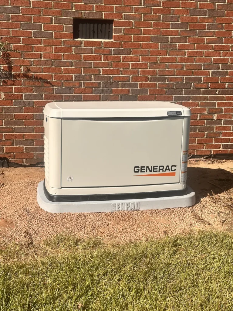 Generac standby generator installed beside a brick home