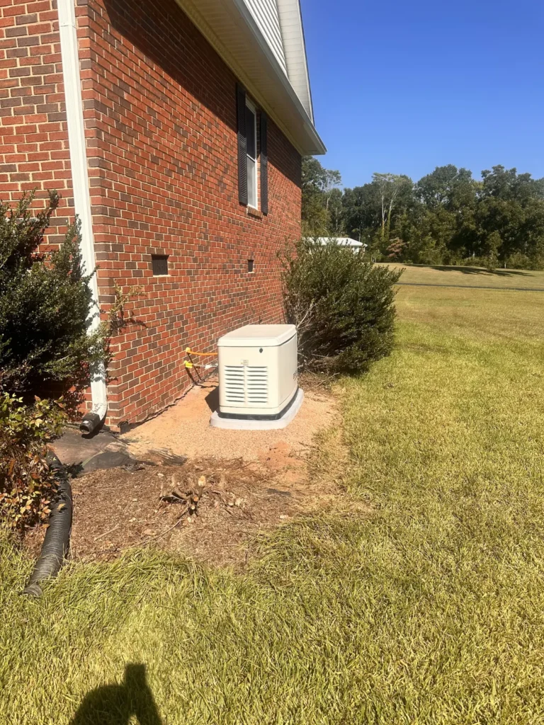 Generac standby generator installed on a prepared pad beside a home
